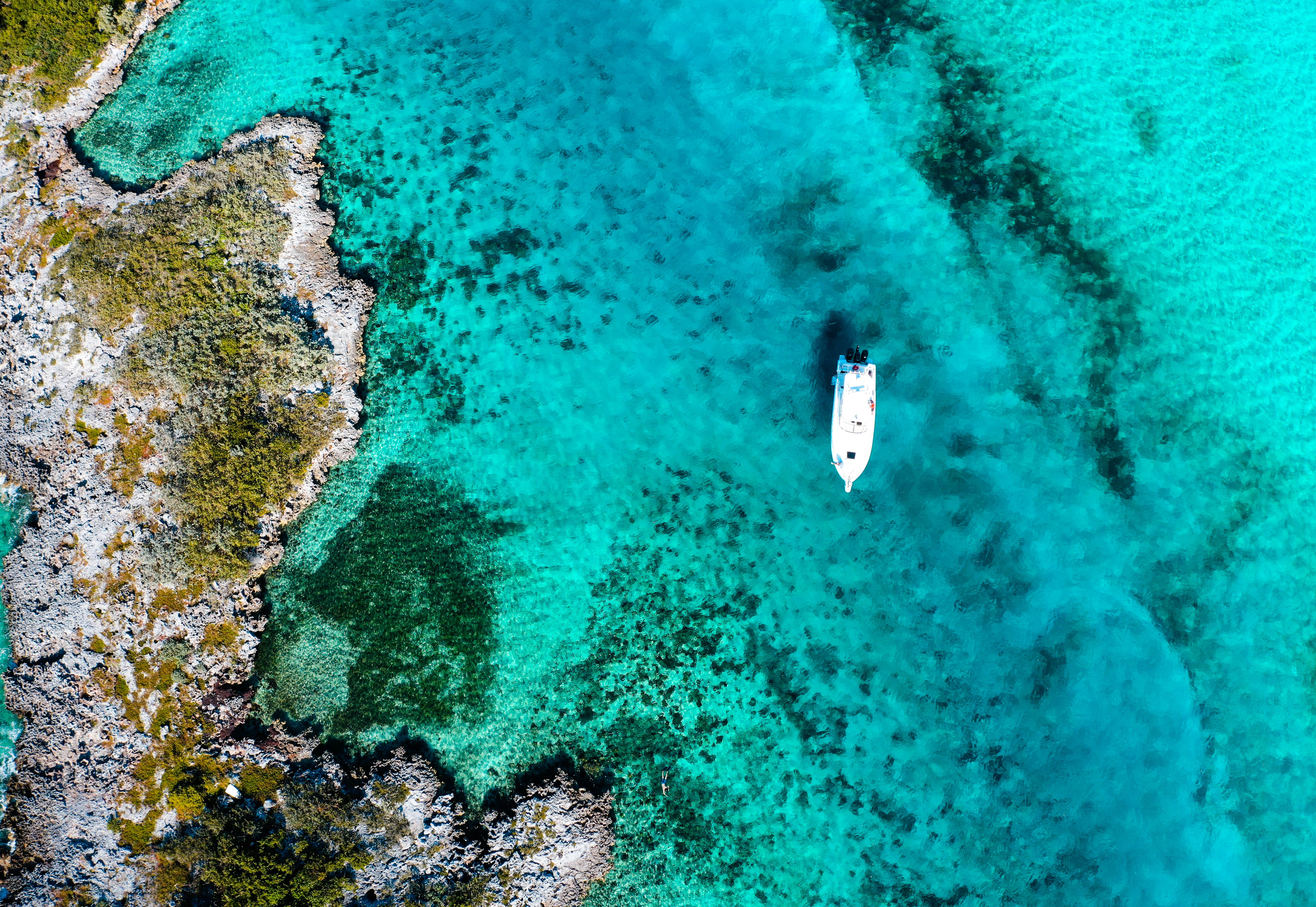 Aerial view of a boat in the turquoise waters of the Bahamas on a Caribbean cruise