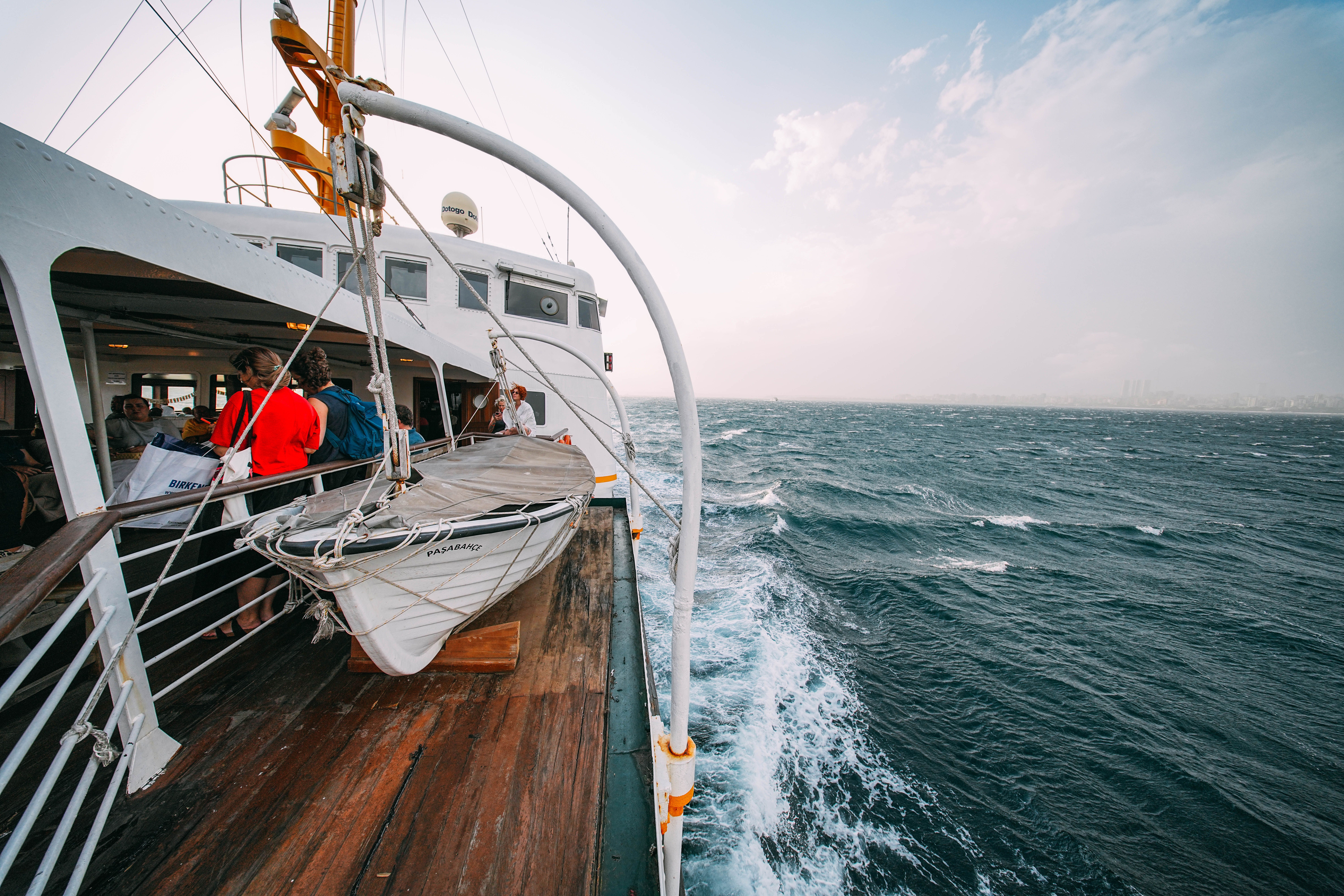 Passengers enjoying the ocean view from a cruise ship deck on an autumn voyage