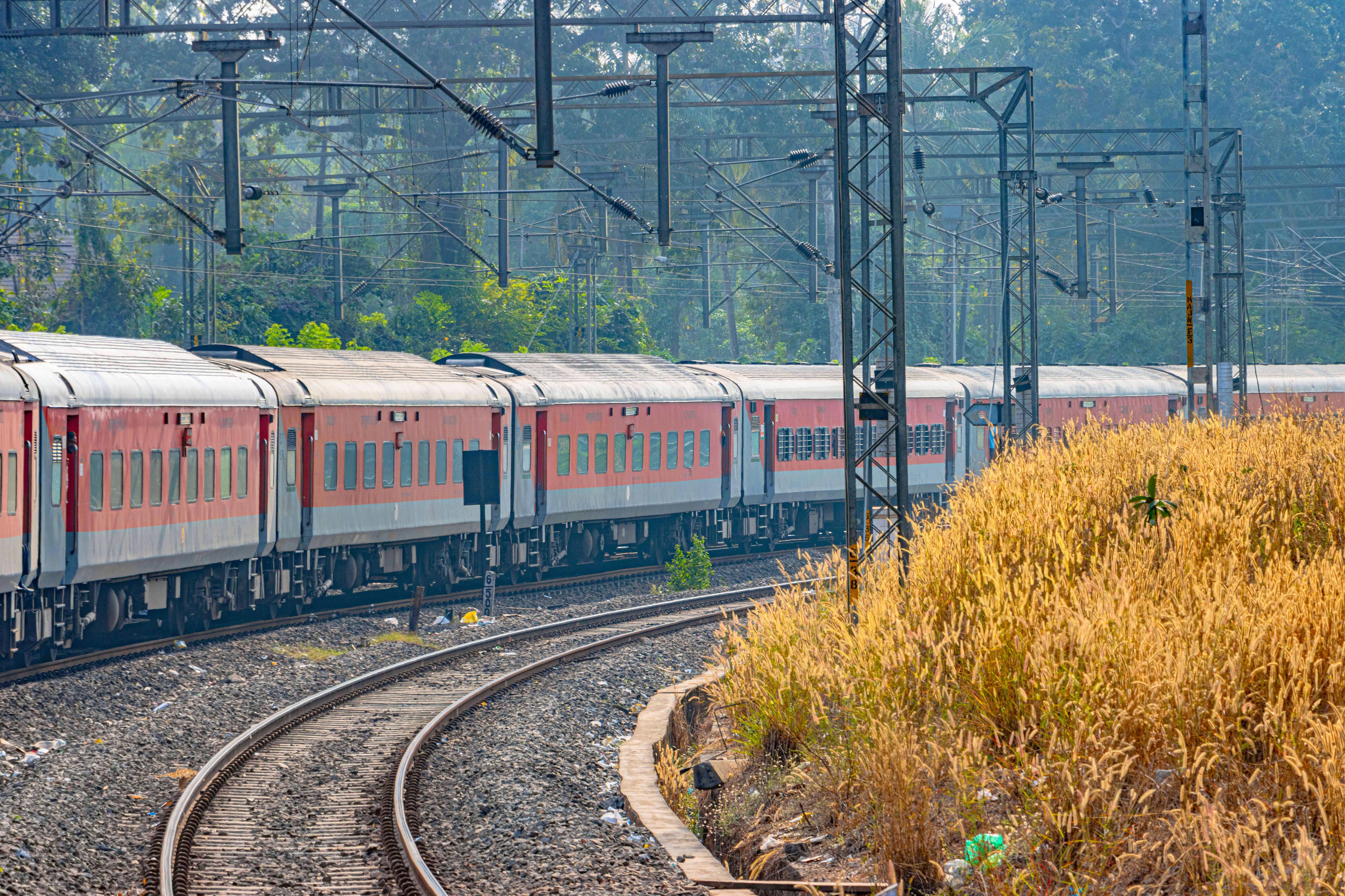 Indian Railways passenger train passing through the scenic countryside of Karnataka, India