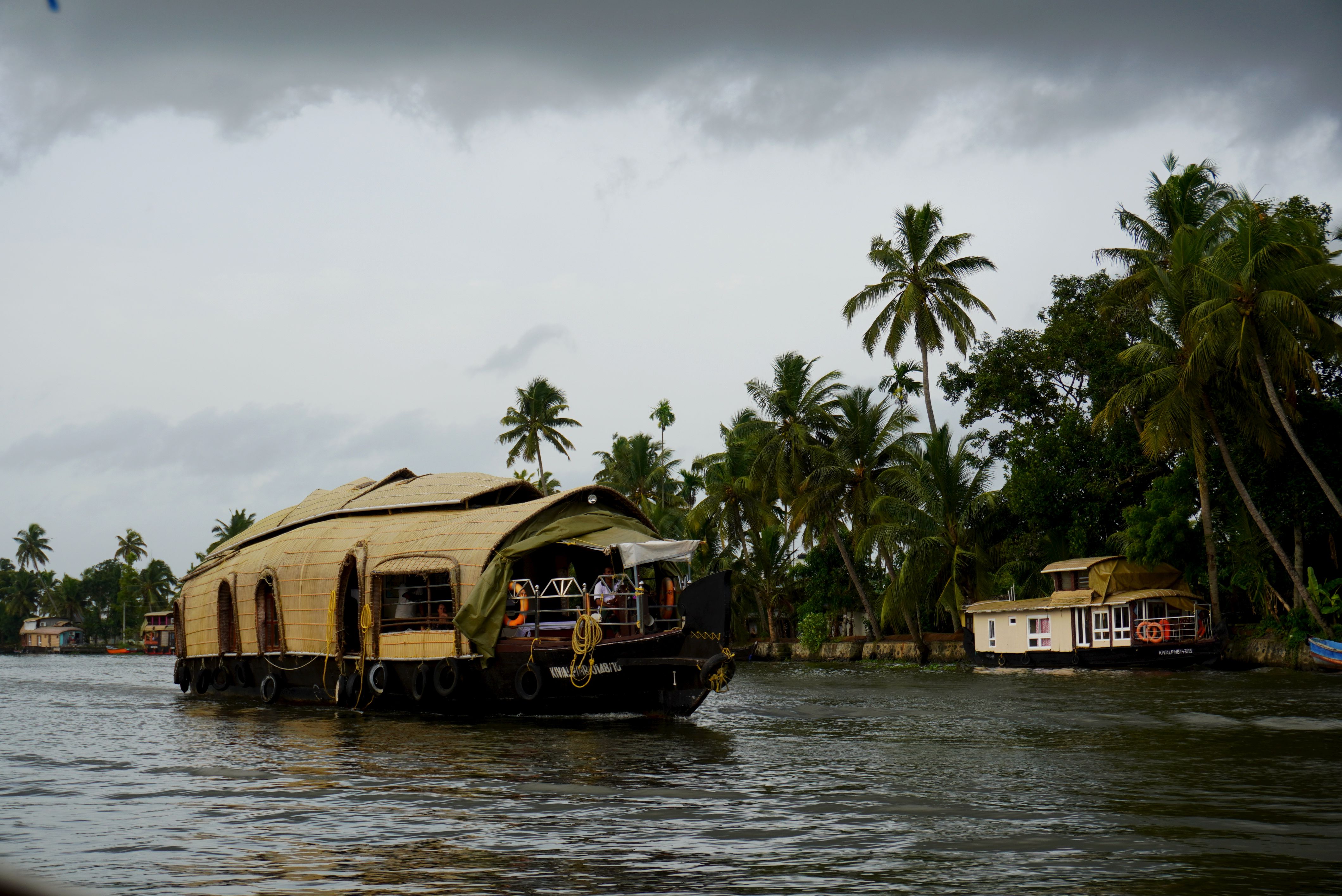 Traditional houseboat cruising through the lush Kerala backwaters in India