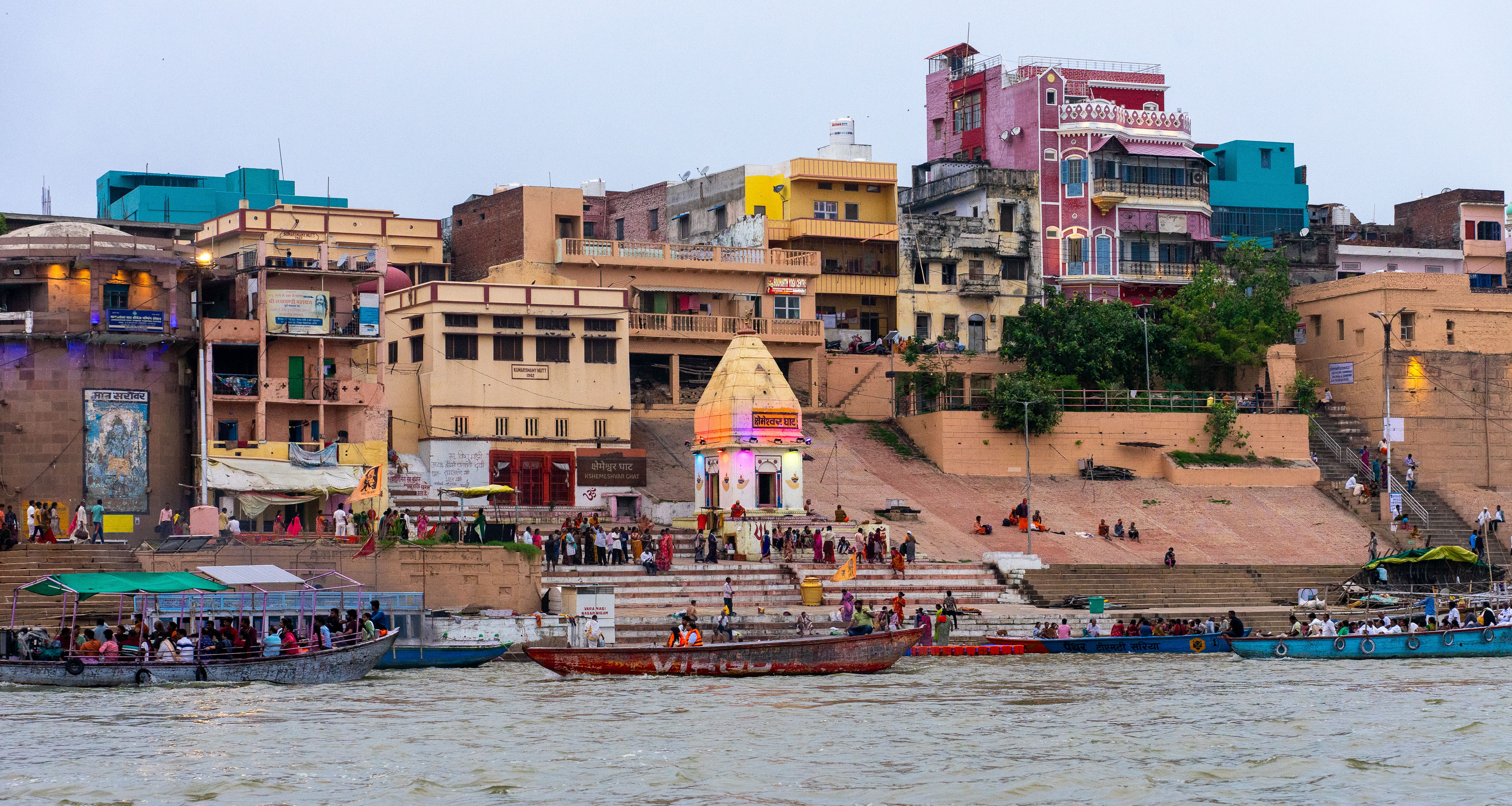 Colorful riverside buildings and boats along the Ganges River ghats in Varanasi, India