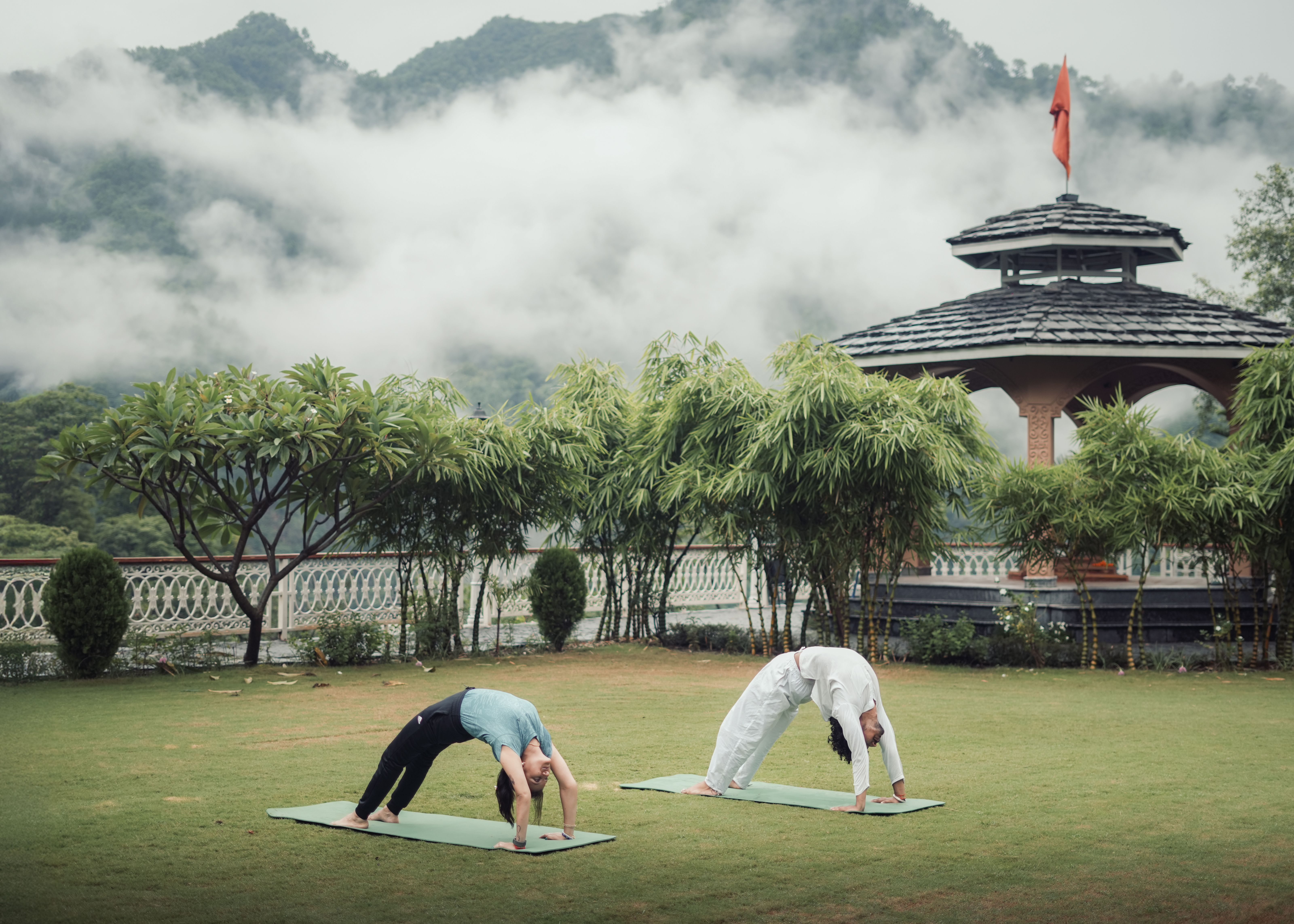 Outdoor yoga session with the Himalayan mountains as a backdrop in Rishikesh, India